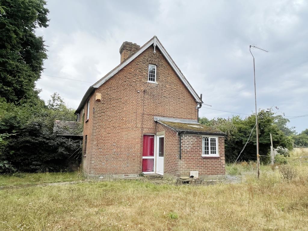 Lot: 138 - RURAL SEMI-DETACHED COTTAGE FOR IMPROVEMENT ON LARGE PLOT - Side view of rural semi in need of refurbishment
